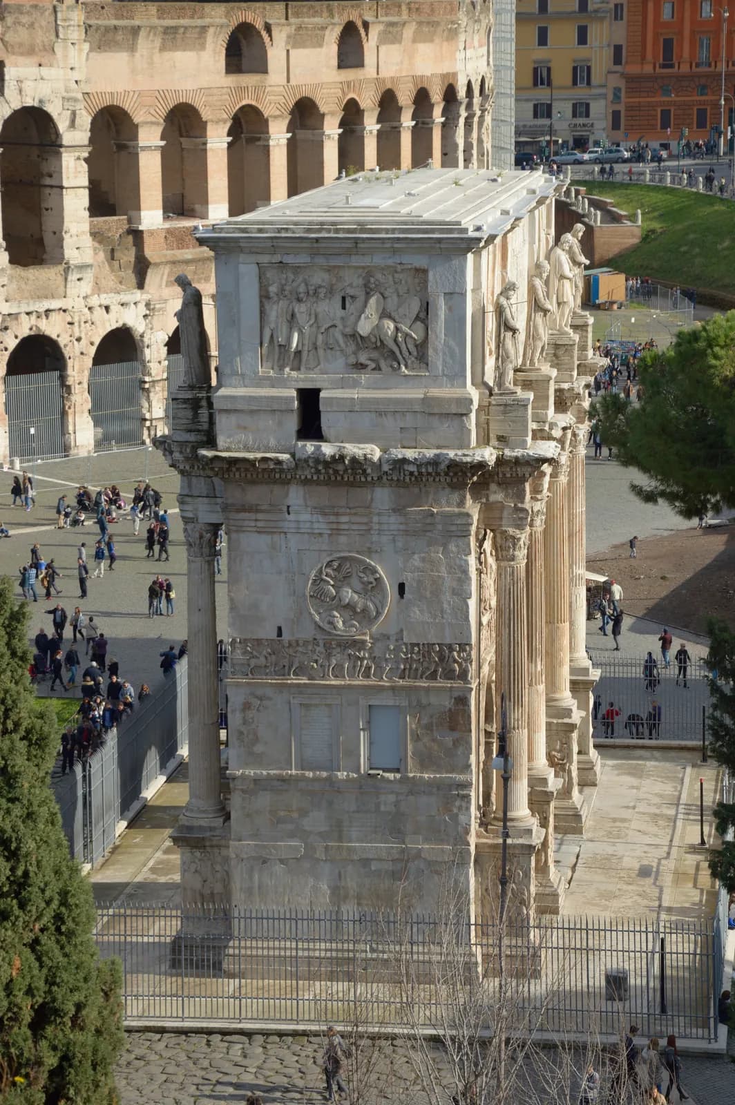The Arch of Constantine in Rome, seen from the side — a triple triumphal arch dedicated in 315 CE, much of its sculptural decoration reused (spolia) from earlier monuments of Trajan, Hadrian and Marcus Aurelius.