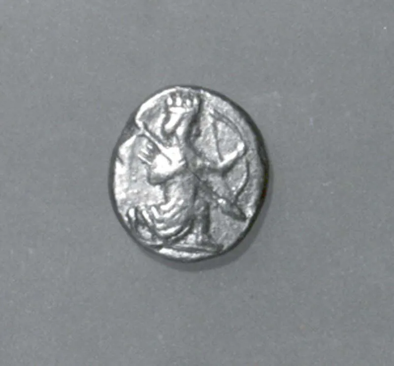 An Achaemenid gold daric showing the Great King in the running-kneeling 'archer' posture, holding a bow and spear — the standard imperial gold coinage introduced under Darius I.