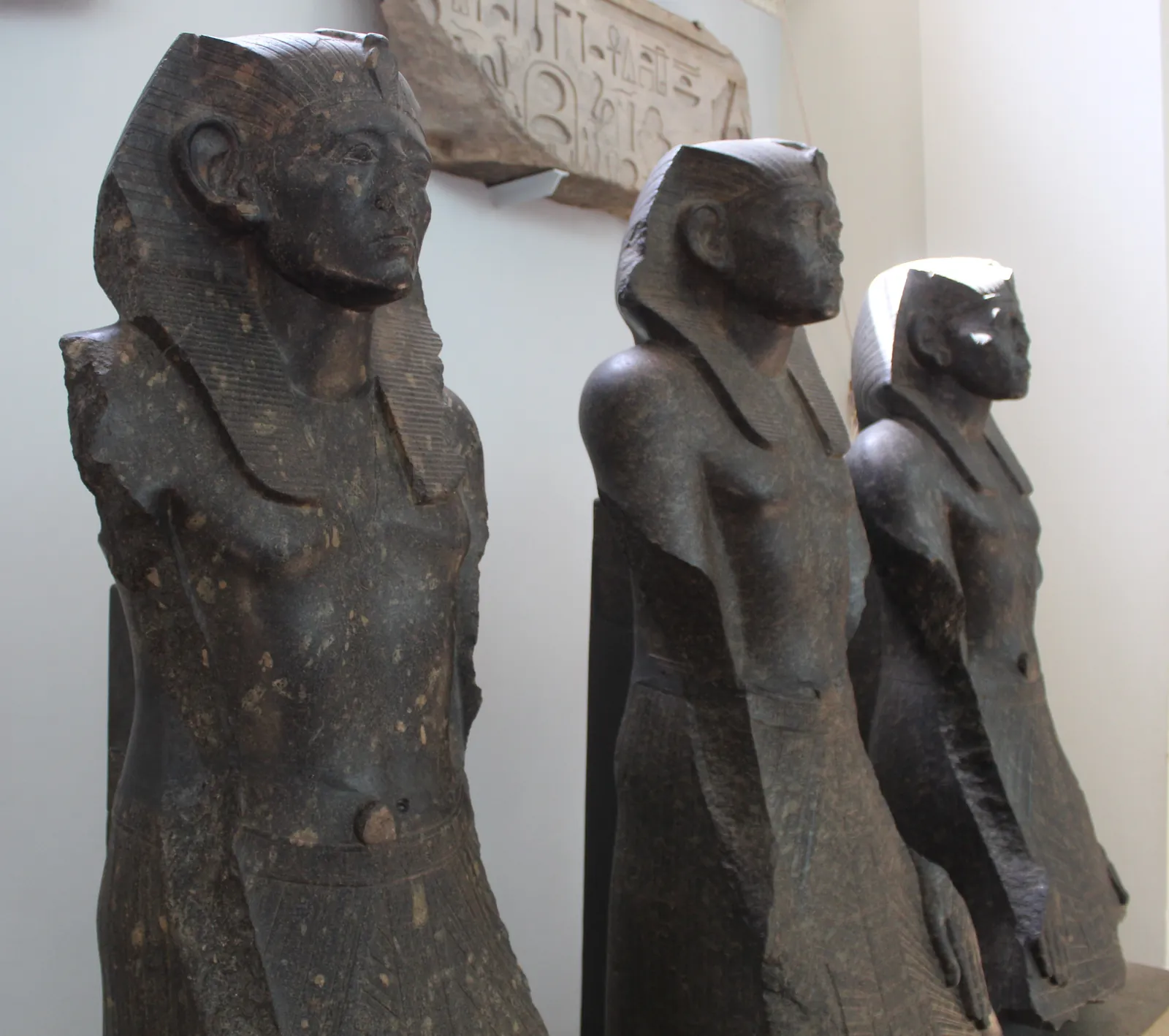 A granite statue of the Middle Kingdom pharaoh Senusret III, the careworn, heavy-lidded royal face that marks the era's new ideal of the king as a burdened shepherd of his people.